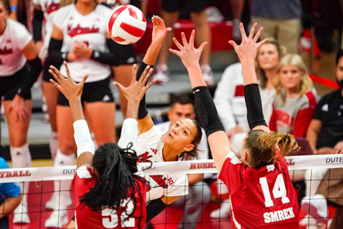 Nebraska Cornhuskers outside hitter Harper Murray attacks against Wisconsin's Carter Booth (52) and middle blocker Anna Smrek during the first set (Oct. 21, 2023).